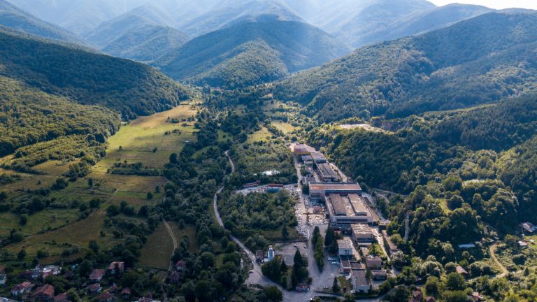 Upravljanje terjatev: Slika prikazuje pogled iz zraka na tovarno marmorja v Berkovici, obkroženo s številnimi drevesi v dolini. Zaradi zavezanosti EOS-a je bilo tradicionalno podjetje ohranjeno.